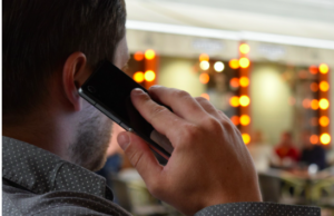 A male on a telephone in a salon.